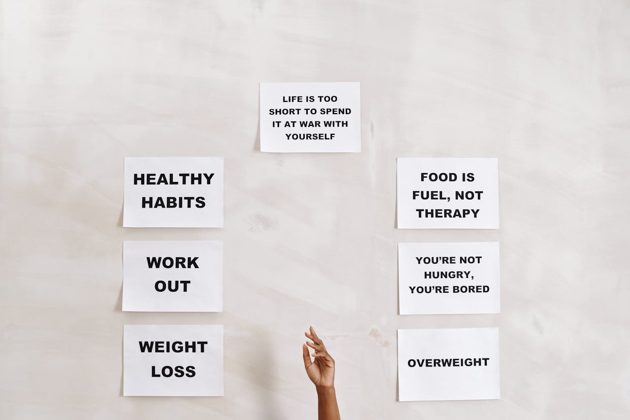 Collection papers on a wall displaying motivational quotes promoting healthy habits and mental well-being